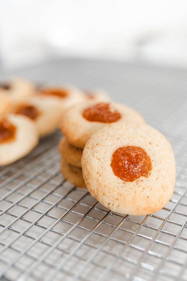 Pepas — goudbruine koekjes met een kuiltje kweepeerpasta, op een rooster